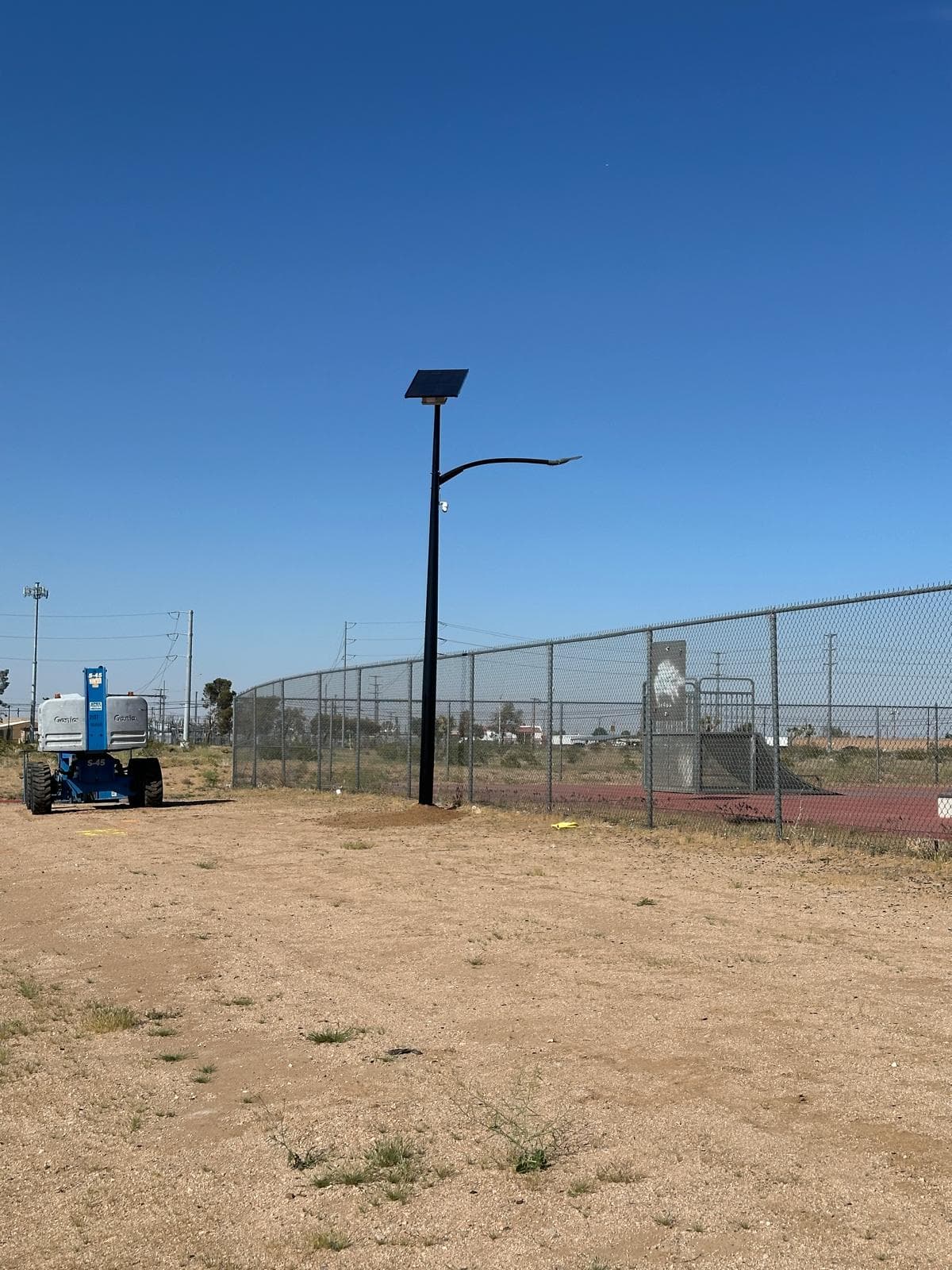 Completed All Seasons pole at the Adelanto skatepark, articulated lift parked in the background