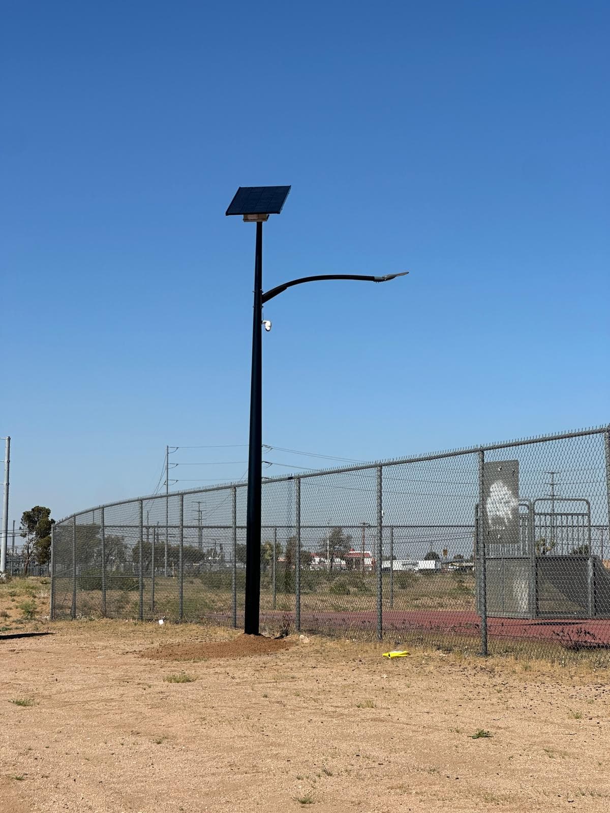 Completed All Seasons pole next to municipal power infrastructure at the Adelanto site