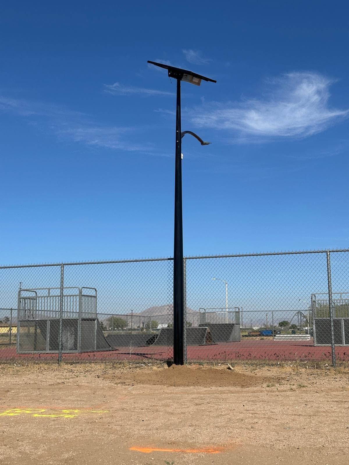 Wider site context view, completed All Seasons pole with the Adelanto skatepark and the ridge line in the background