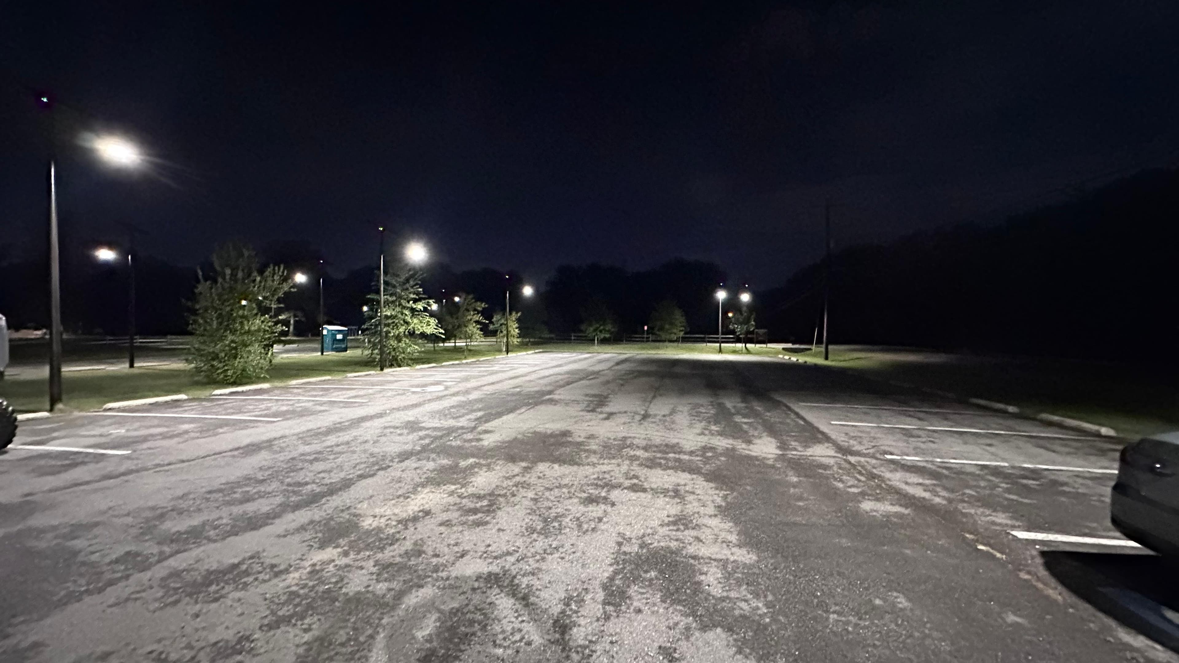 Riverview Park parking lot at night with multiple All Seasons poles lighting the empty parking spaces