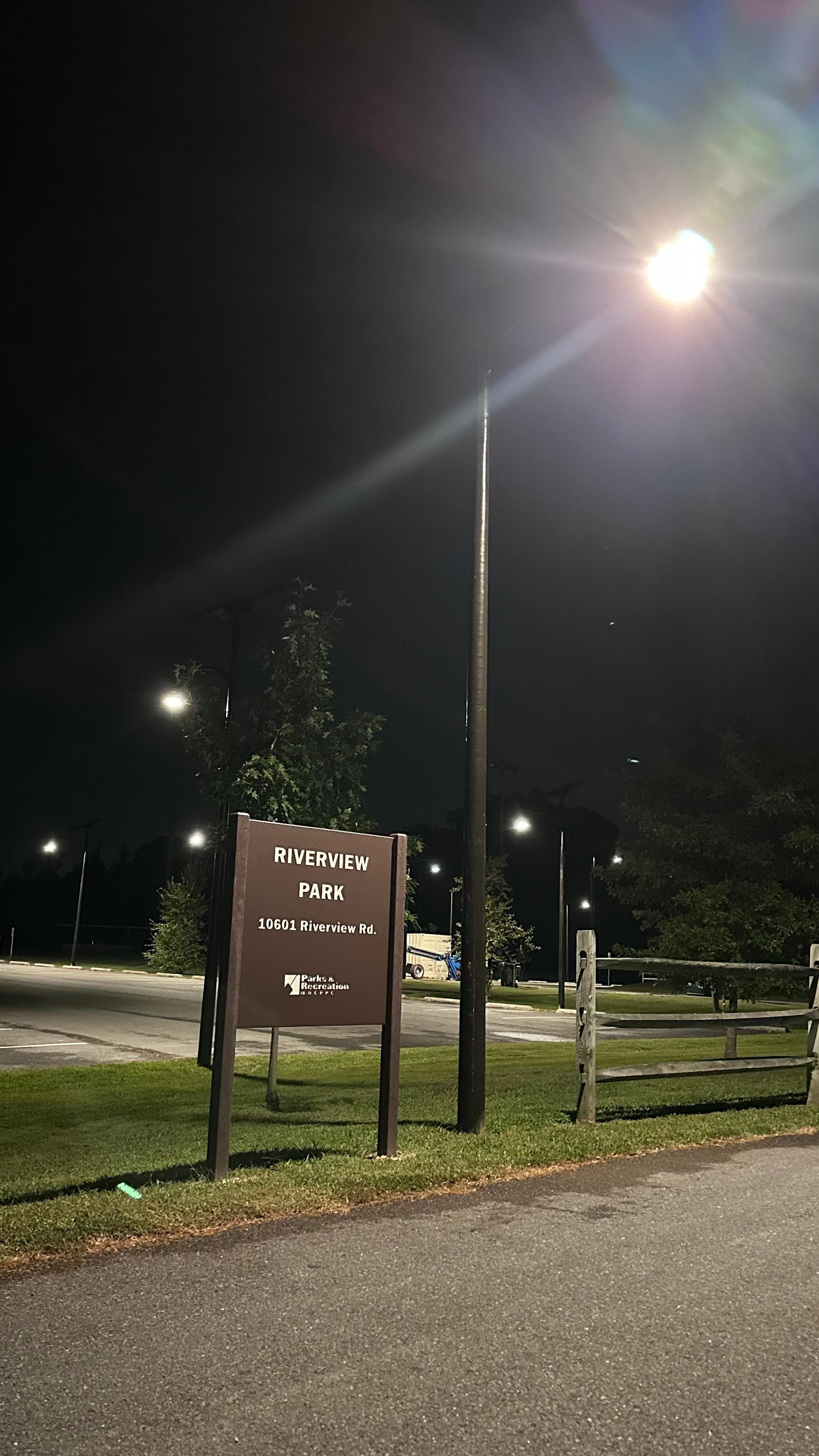 All Seasons pole at the Riverview Park entrance, illuminating the park sign at 10601 Riverview Rd at night